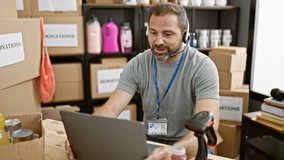 Middle-aged man with beard working on laptop in donation center warehouse, expressing various emotions. - Powered by Shutterstock - Get 15% off with code: PIKWIZARD15