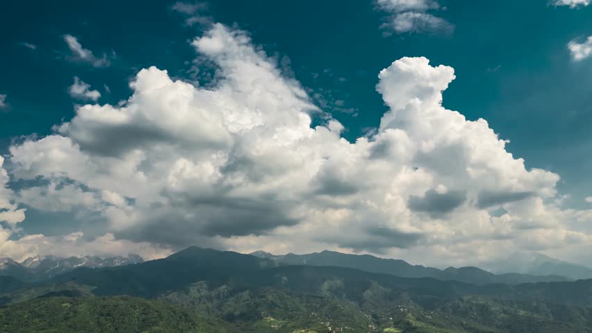 Big clouds over the mountains aerial timelapse