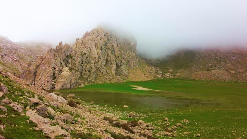 Gulmim lake at the top of the Djurdjura mountain Algeria Kabylie with the passage of clouds
