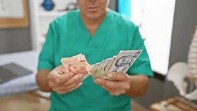 A mature man in medical scrubs examines assorted singaporean dollars indoors at a clinic. - Powered by Shutterstock - Get 15% off with code: PIKWIZARD15