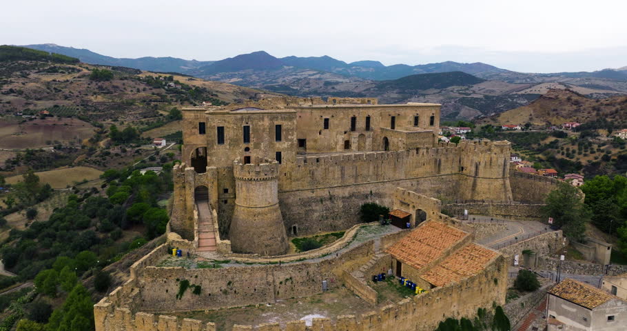 Exterior Of Medieval Castle In Rocca Imperiale With Mountain Views In Cosenza, Italy. - aerial shot