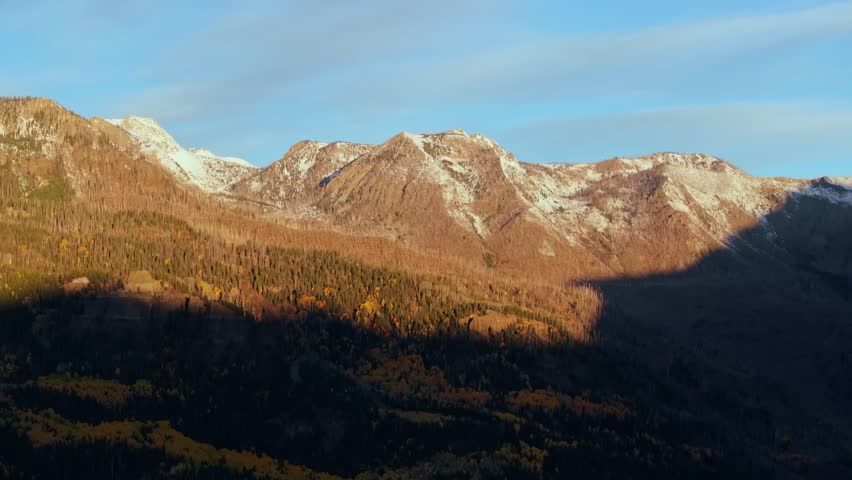 Mountain landscape in Wolf Creek, Pagosa Springs, CO with snow-capped peaks and fall foliage