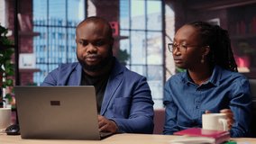 Woman completing spreadsheets on notebook, entering numerical data into cells, calculating totals. African american couple analyzing online information for an accounting task. Camera B. - Powered by Shutterstock - Get 15% off with code: PIKWIZARD15