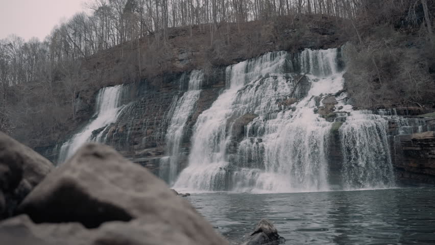 Large waterfall cascading down a cliff in the hills of Tennessee during the winter