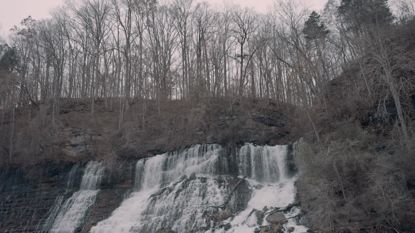 Large waterfall cascading down a cliff in the hills of Tennessee during the winter