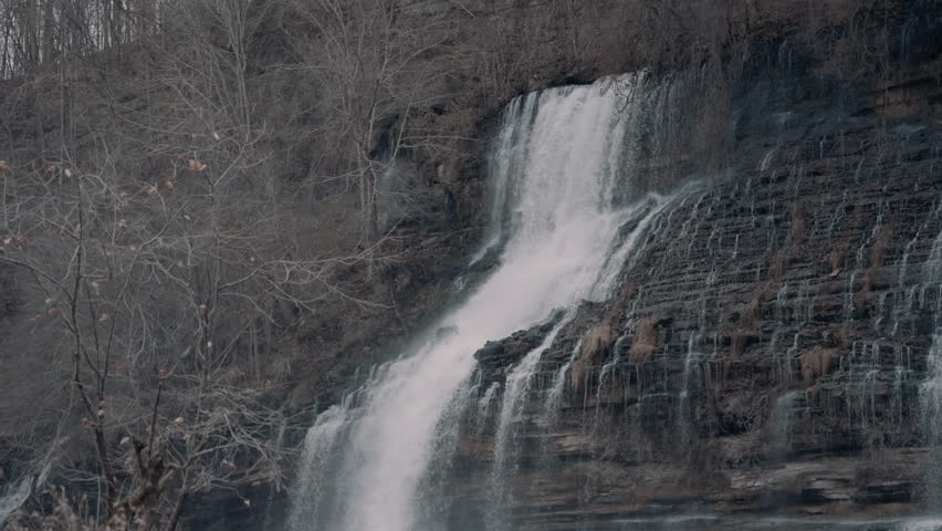 Large waterfall cascading down a cliff in the hills of Tennessee during the winter