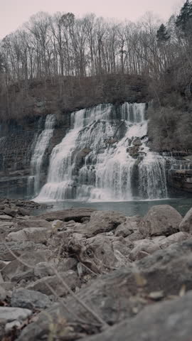 Large waterfall cascading down a cliff in the hills of Tennessee during the winter