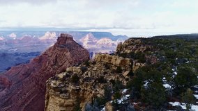 Drone of stunning Grand Canyo view of rugged cliffs, snowy, vivid terrain, 4K - Powered by Shutterstock - Get 15% off with code: PIKWIZARD15