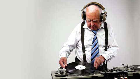 a very funky elderly grandpa dj mixing records
