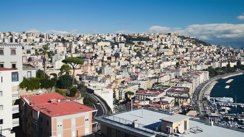 Stunning sunset panorama of Naples from Posillipo, showcasing the city, coastline, and Mount Vesuvius