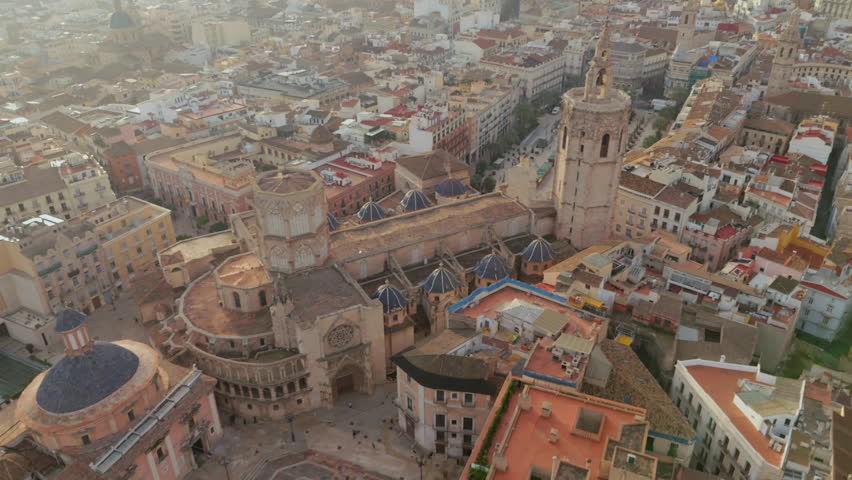 Cinematic Aerial drone of Valencias historic old town from a unique vantage point. Stunning Plaza de la Virgen and magnificent Cathedral of Santa Maria, landmarks showcasing citys rich architecture