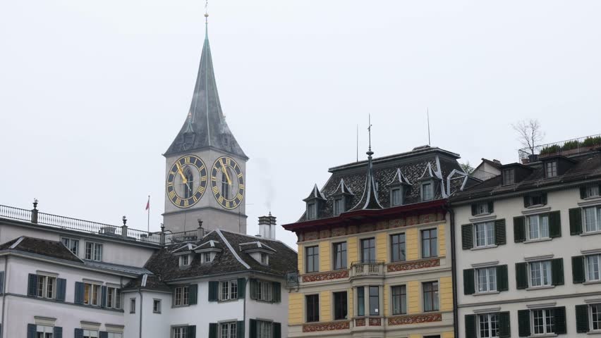 zurich’s old town riverside switzerland limmat river historical buildings churches clock tower scene reflects swiss heritage close up panning shot zurich st. peter fraumünster church