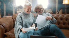 Cheerful retired couple celebrate holding bank documents notification of disbursed loan last installment, look at the camera and smile positive reaction to the good news. Paid off bank loan - Powered by Shutterstock - Get 15% off with code: PIKWIZARD15