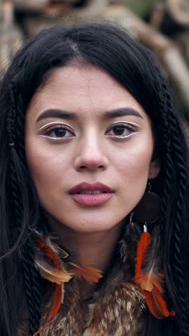asian young woman covers her face with her hands with painted eyes on her palms. portrait of asian young mestizo woman