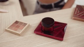 Young woman making beauty and cosmetic tutorial video content for social media. Beauty blogger smiles to camera while showing how to beauty care to audience or followers. Adit - Powered by Shutterstock - Get 15% off with code: PIKWIZARD15