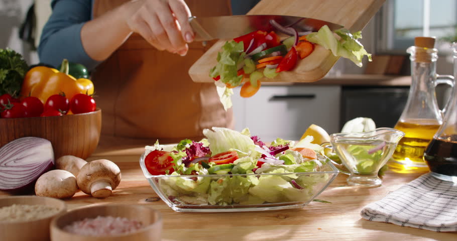 Freshly Prepared Mediterranean Salad with Colorful Organic Vegetables, Nutritious Ingredients, Wellness Food, Healthy Diet, Balanced Nutrition, Wholesome Meal, Cooking Process in Bright Daylight