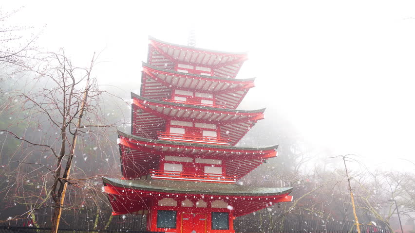 Snow falling at Red pagoda in Japan.
