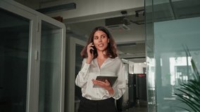 Focused business executive manager having communication call, consult working remotely. Female CEO entrepreneur businesswoman walking in office, talking on mobile cellphone with clients, partners - Powered by Shutterstock - Get 15% off with code: PIKWIZARD15
