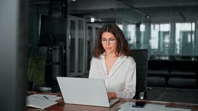 Focused young businesswoman professional it specialist using pc doing online banking analysing at workplace. Latin hispanic middle age business woman working on laptop computer AI app in modern office - Powered by Shutterstock - Get 15% off with code: PIKWIZARD15