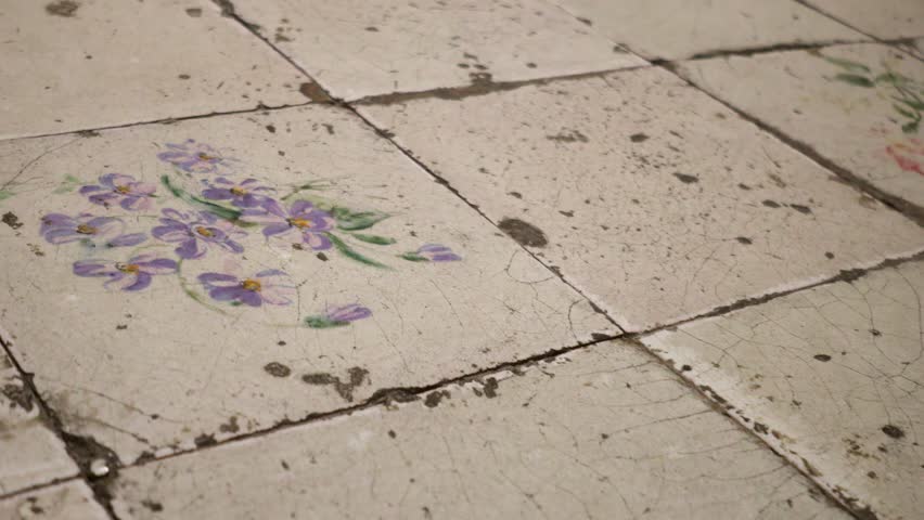 Antique white ceramic tile floor with coloured drawings