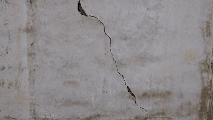 Ancient wall with cracks and windows with diamond-shaped grilles vertical panorama