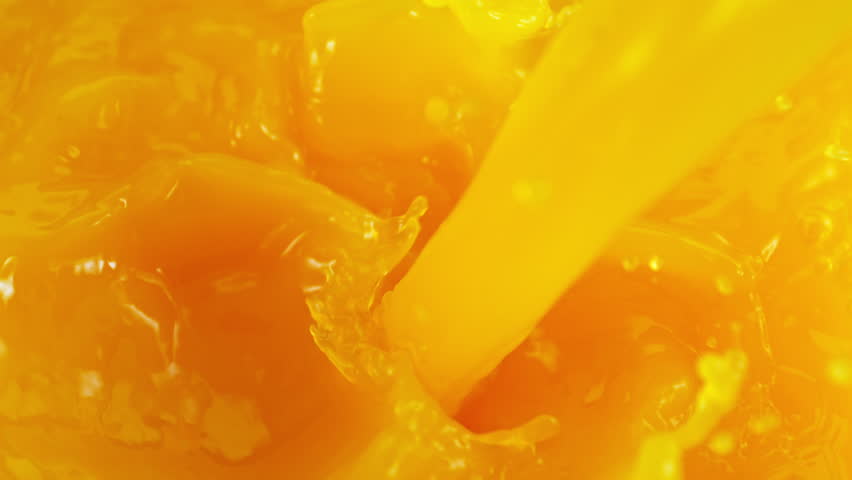 Super Slow Motion Detail Shot of Pouring Fresh Orange Juice at 1000fps.