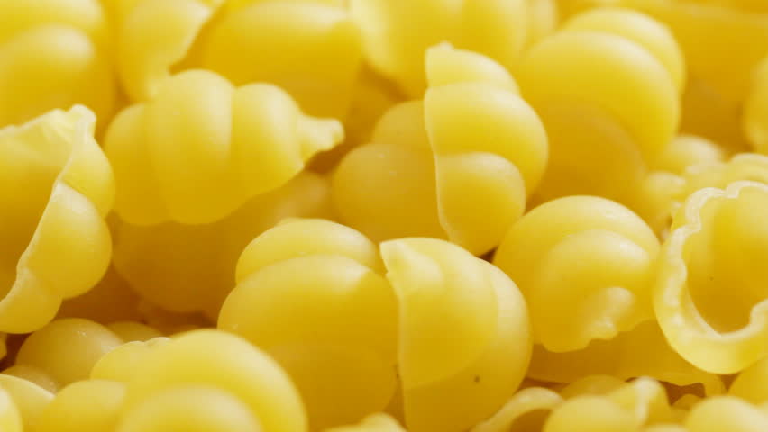 Close up of dried pasta shells rotating