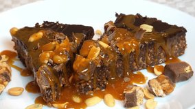 I'm tasting the Delicious chocolate Snickers cake with lots of peanuts and caramel - Powered by Shutterstock - Get 15% off with code: PIKWIZARD15