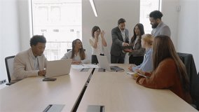 In a modern conference room, diverse business professionals collaborate, analyzing financial data and discussing sales reports, clapping to their boss,decisions for corporate growth and success - Powered by Shutterstock - Get 15% off with code: PIKWIZARD15