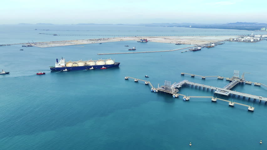 LNG (Liquified Natural Gas) tanker anchored in Gas terminal gas tanks for storage. Oil Crude Gas Tanker Ship. LPG at Tanker Bay Petroleum Chemical or Methane freighter export import transportation 