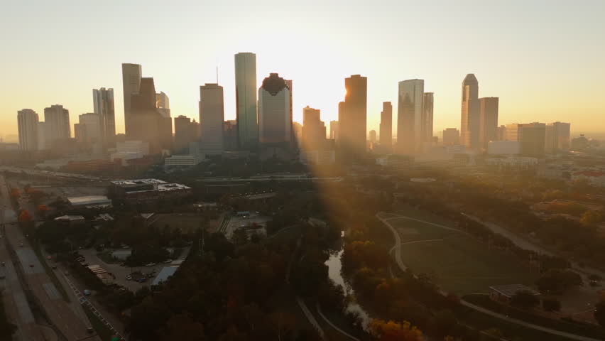 Experience the breathtaking beauty of Downtown Houston at sunrise, featuring a stunning aerial view of the vibrant skyline and natural surroundings for an unforgettable, sensory experience, Texas, USA