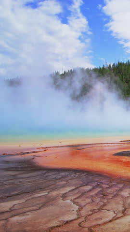 The stunning landscape, known for its captivating beauty, showcases mesmerizing steam from geothermal areas, with vibrant colors and immense natural beauty that captivates visitors from every angle