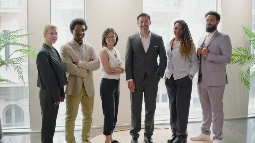 Happy diverse business team people in office standing in row looking at camera. Multiethnic professional employees posing together for corporate portrait, leadership. Slow motion panning shot - Powered by Shutterstock - Get 15% off with code: PIKWIZARD15