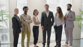 Happy diverse business team people in office standing in row looking at camera. Multiethnic professional employees posing together for corporate portrait, leadership. Slow motion panning shot - Powered by Shutterstock - Get 15% off with code: PIKWIZARD15