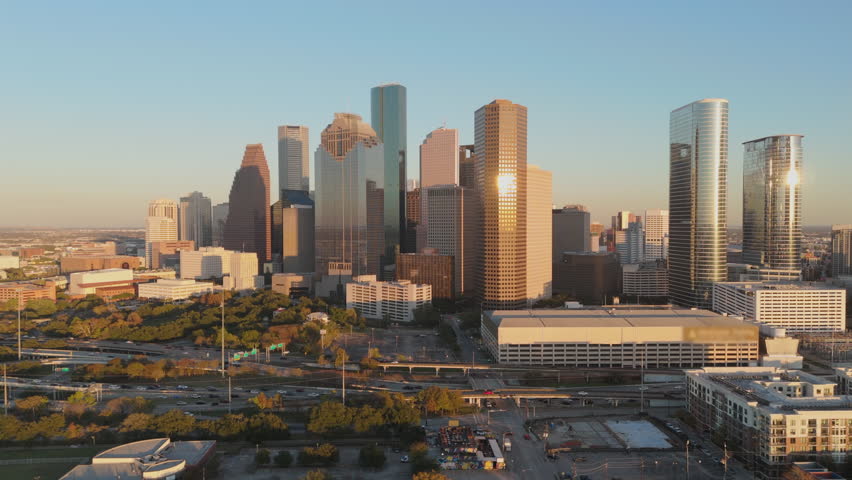 Aerial view highlights the vibrant skyline of Downtown Houston, showcasing its modern architecture and lush green spaces that embody the essence of urban life in this dynamic city. Houston, Texas, USA