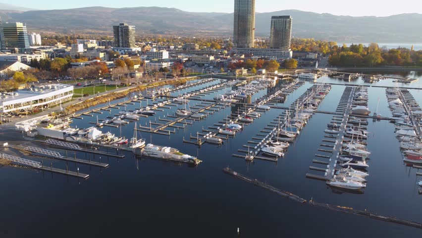 Downtown Waterfront, Kelowna, BC, Canada. Panorama Calm Okanagan Lake Landscape. British Columbia Interior in the Fall Autumn Season with Colourful Trees. Evening Sunset, City Park Walking Path