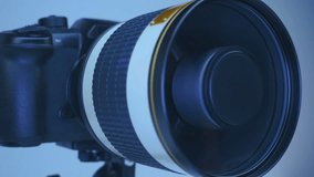 A professional camera on a tripod with a powerful mirror zoom lens that reflects the ring LED light. Closeup. Macro - Powered by Shutterstock - Get 15% off with code: PIKWIZARD15