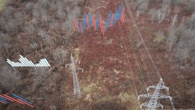 Aerial drone shot flying over power lines and electricity pylons, with digital graphs and data overlays representing rising electricity prices in Europe and worldwide. Energy cost crisis, power supply - Powered by Shutterstock - Get 15% off with code: PIKWIZARD15