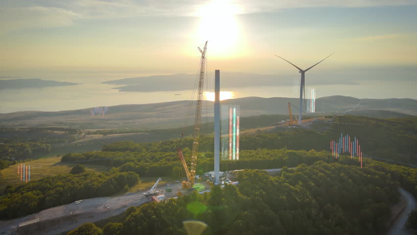 Wind turbines under construction on large wind farm site, with digital graphs and data overlays emphasizing the importance of renewable energy and sustainable power supply. Green energy transition