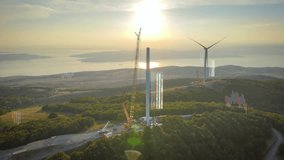 Wind turbines under construction on large wind farm site, with digital graphs and data overlays emphasizing the importance of renewable energy and sustainable power supply. Green energy transition - Powered by Shutterstock - Get 15% off with code: PIKWIZARD15