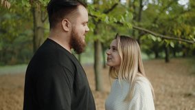 Romantic and intimate moment between a young couple in a scenic autumnal park, showing love and affection as they gently touch and gaze at each other. Romantic Couple in Autumn Park - Powered by Shutterstock - Get 15% off with code: PIKWIZARD15