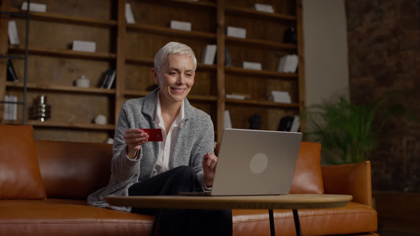 Senior woman shopping online with credit card
