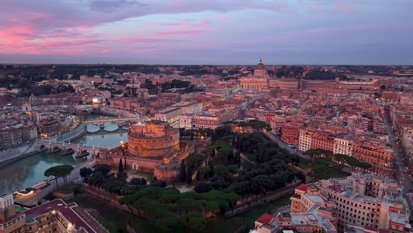 4k Aerial view of the Castel Sant'Angelo and St. Peter's Basilica in Rome at sunrise. Drone point of the castle and the city of Vatican. Italy