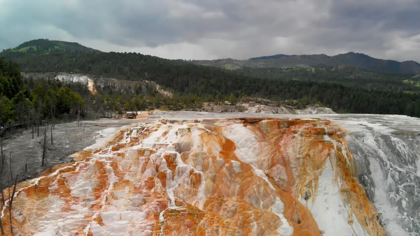Mammoth Hot Springs, Yellowstone National Park. Aerial view of mountain and countryside. Slow motion
