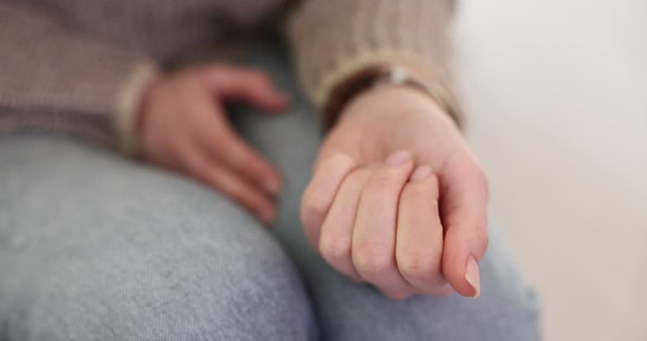 Woman opens palm with small white pills sitting in light room. Female patient addicted from painkiller drugs asks for help in healthcare facility