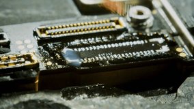 4K close-up video of a soldering iron heating the braid to clean the circuit board. The detailed process is captured at 30fps, showcasing the precision of the repair work in a static shot. - Powered by Shutterstock - Get 15% off with code: PIKWIZARD15