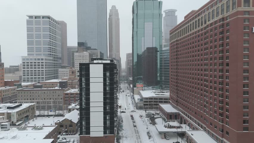 Downtown Minneapolis showcasing modern skyscrapers, historic buildings and snow-covered streets in winter
