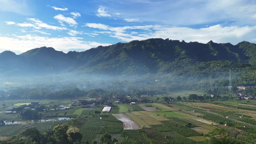 Aerial view of the indonesian countryside with Menoreh Hill and surrounding mountains.