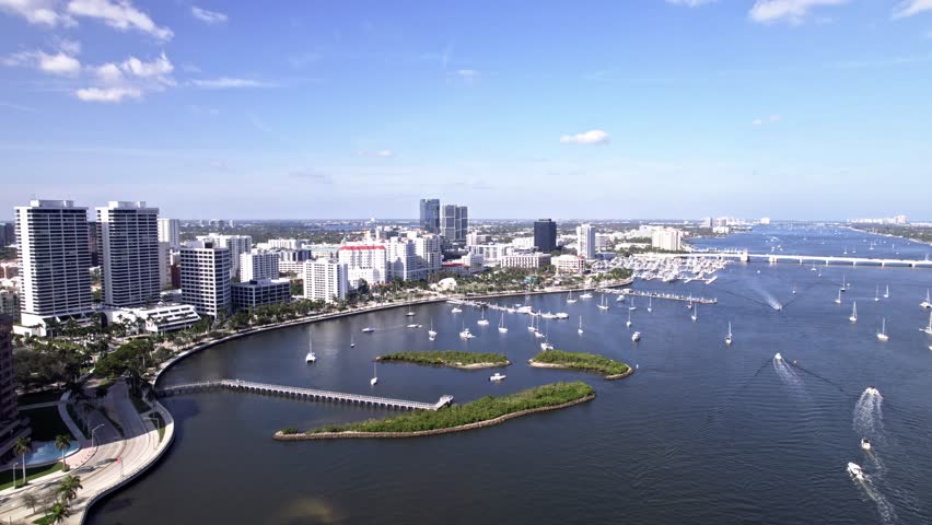 Push in tilt down drone shot of West Palm Beach harbor with yachts and boats in Florida, USA