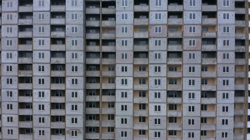 Building facade with numerous windows showcasing urban architecture in a city